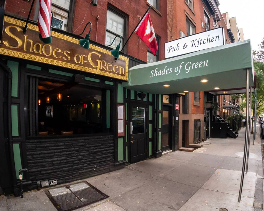 The Shades of Green Pub exterior with a Virginia Tech flag above the entrance